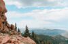Rocky Colorado mountain overlook with trees and distant ridgelines